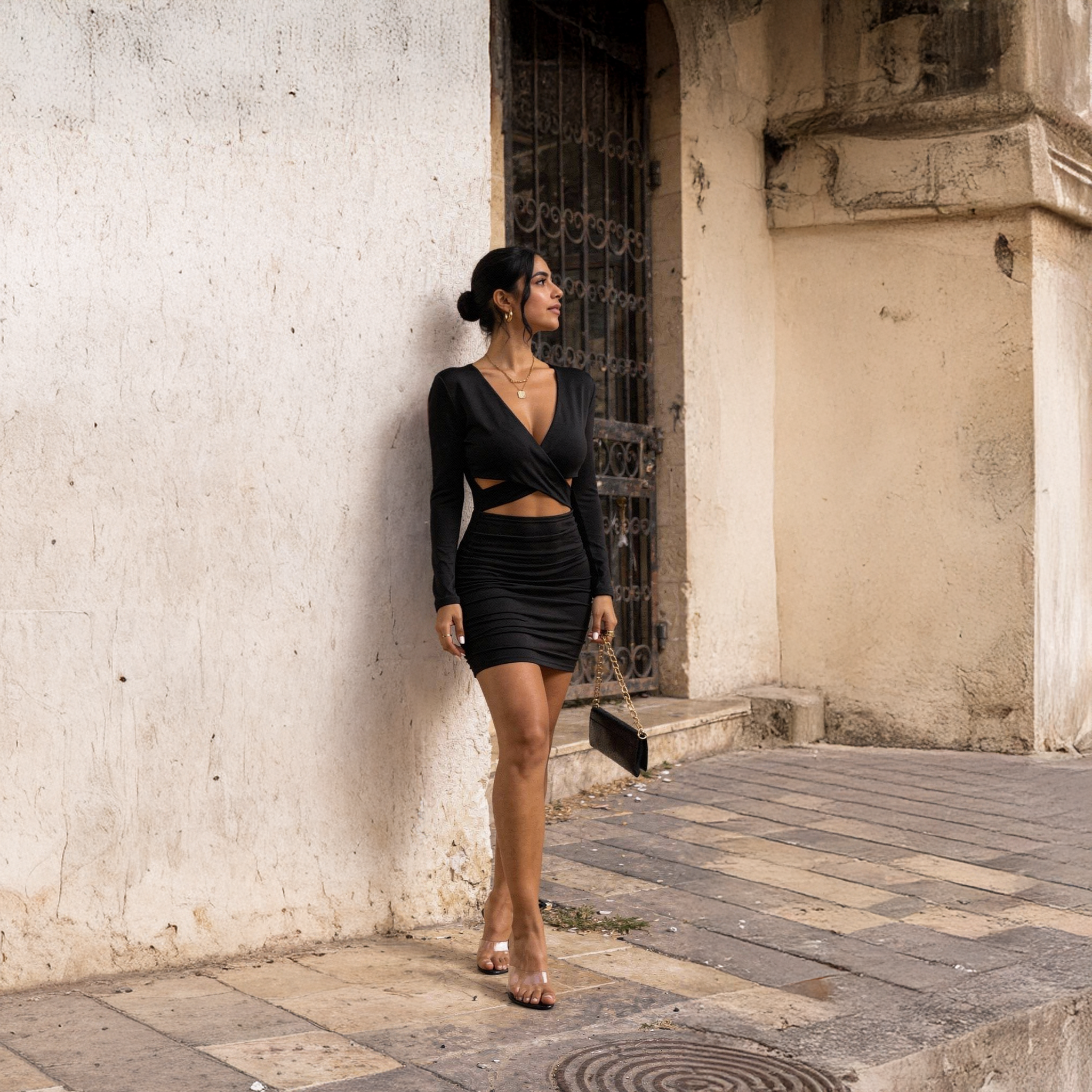 Black ribbed knit midi dress for women with long sleeves and a stylish scoop neckline, photographed inside a historic stone house in Saida.

