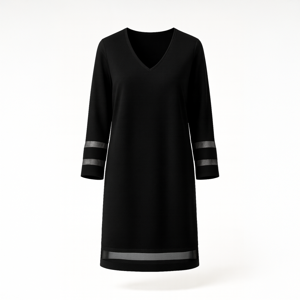 Structured black midi dress with a smooth base fabric and dramatic sheer tulle detailing on the sleeves or overlay, photographed in a modern Raouche apartment.
