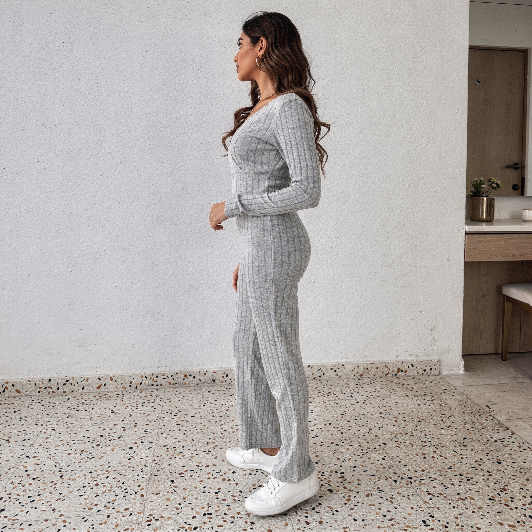 Grey ribbed knit two-piece set for women featuring a long sleeve V-neck top and flared pants, soft loungewear outfit.
