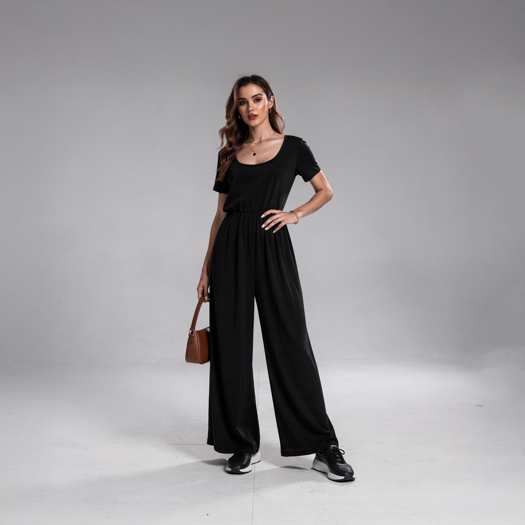 Tailored black wide-leg jumpsuit for women with a flattering V-neckline and defined waist, photographed in a clean studio setting.

