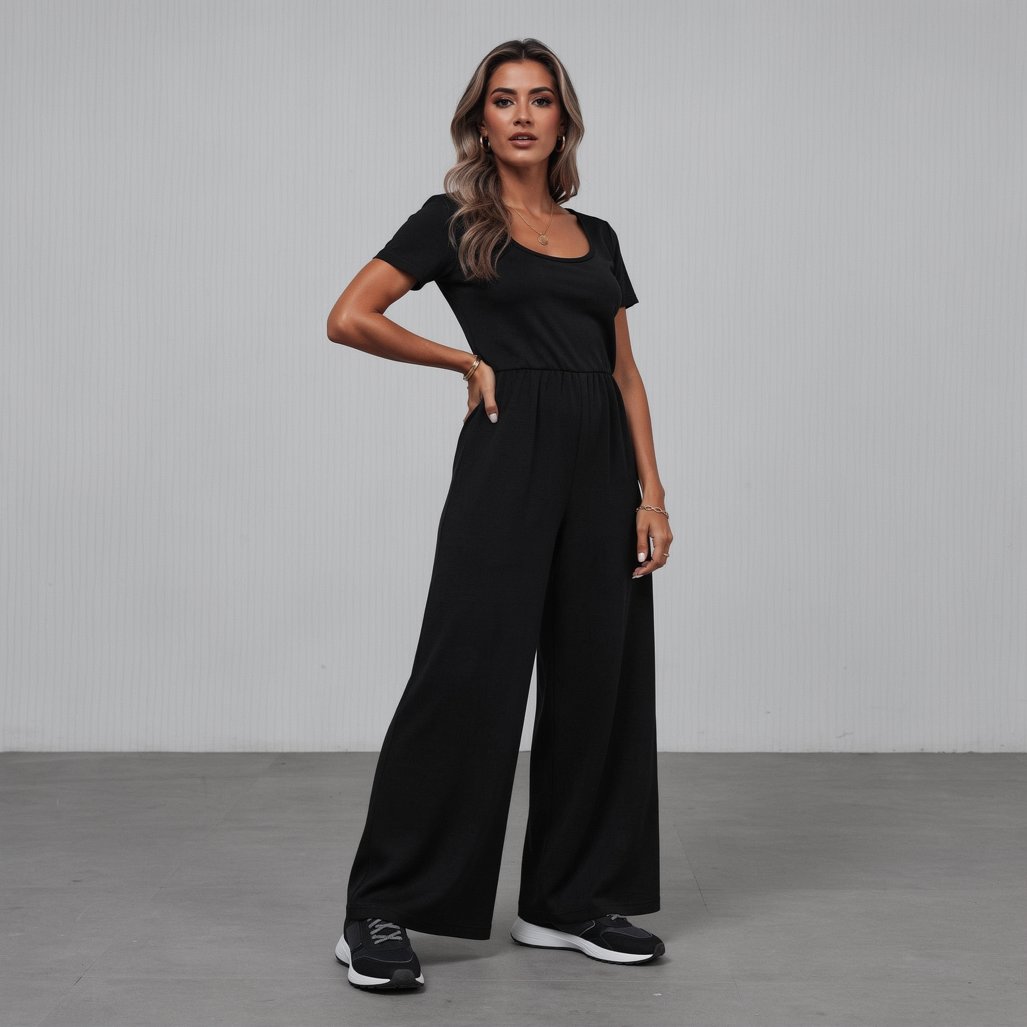 Tailored black wide-leg jumpsuit for women with a flattering V-neckline and defined waist, photographed in a clean studio setting.

